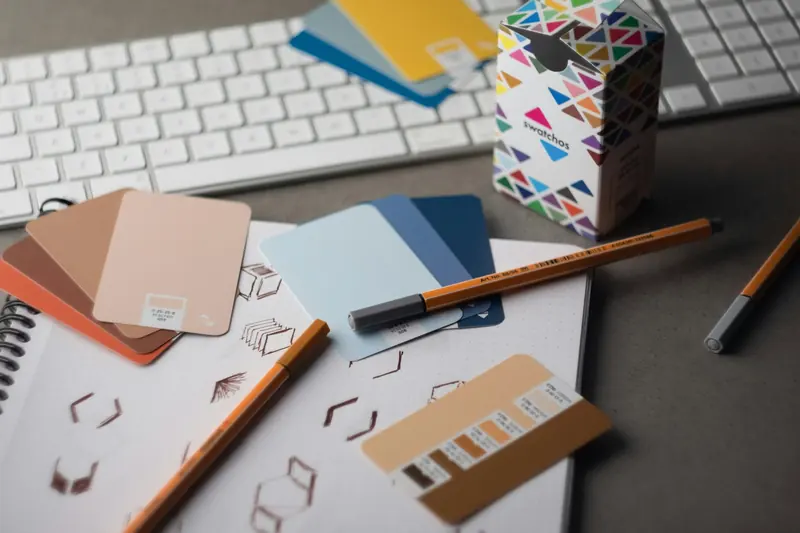 Designer desk with colour swatches and cover sketches