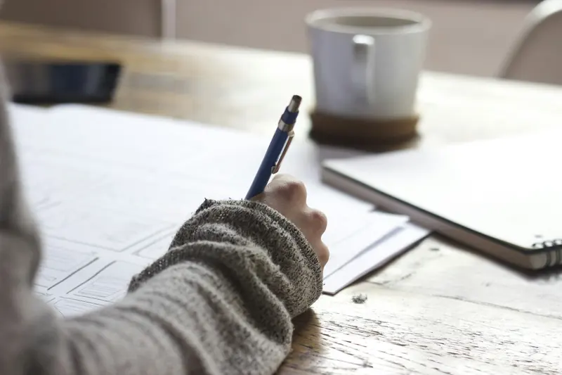 Author writing at a desk
